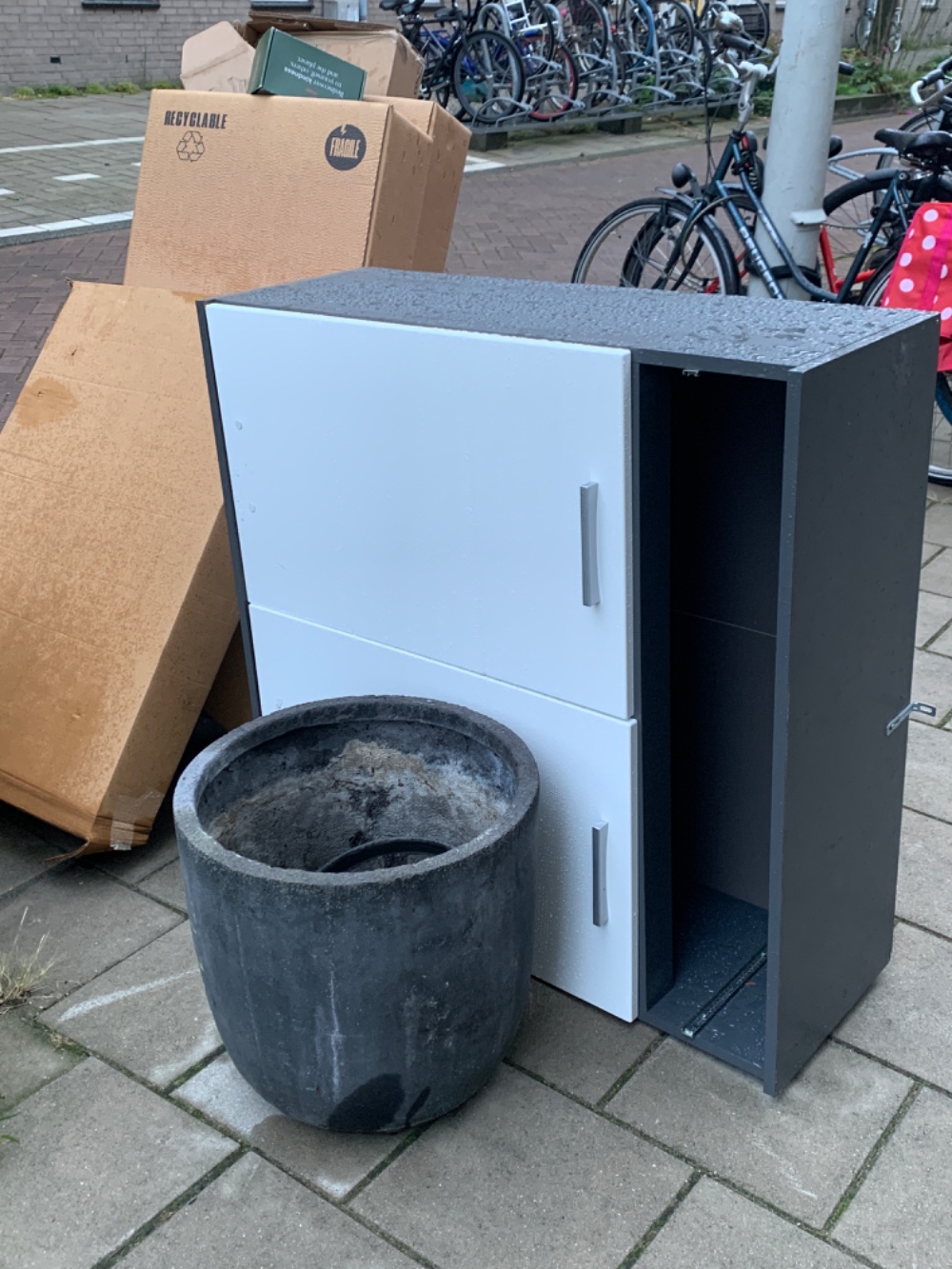 Huge plant pot and a kitchen cabinet