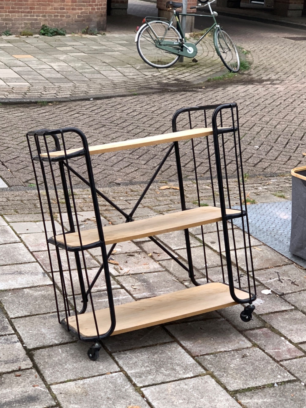 Some kind of shelf with one wheel missing