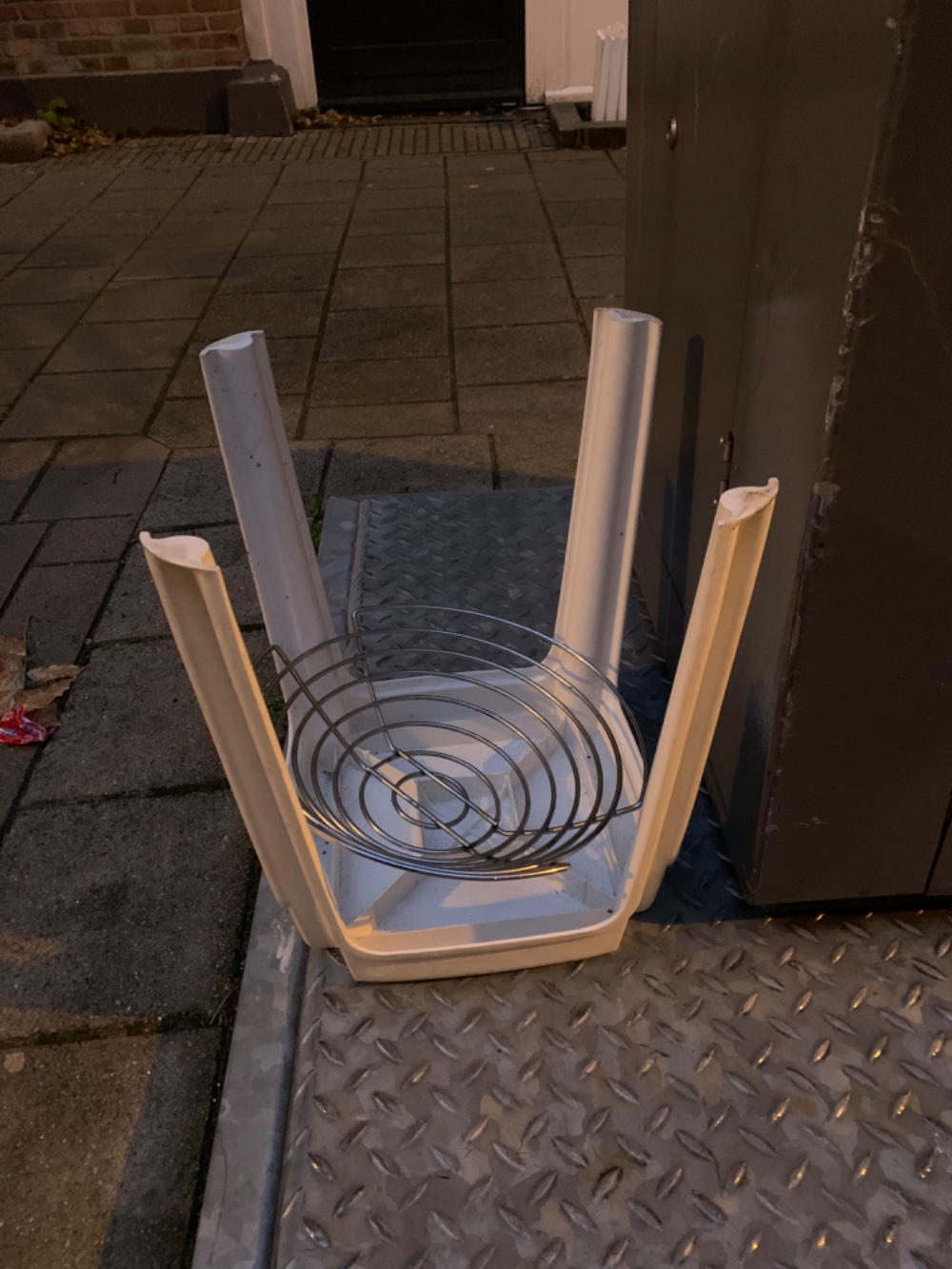 Plastic chair and metal fruit bowl