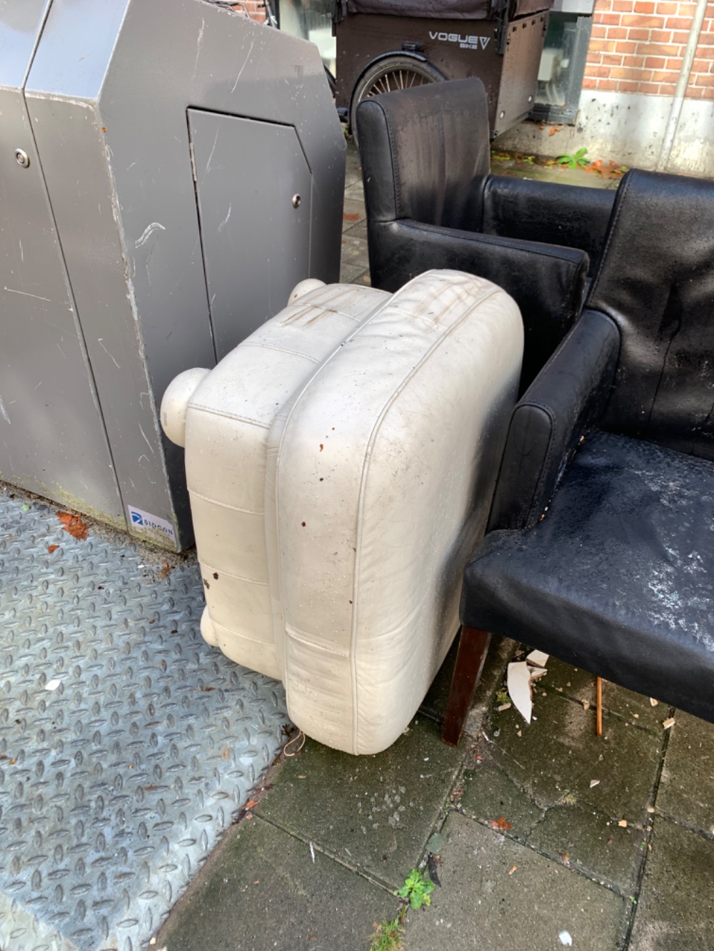 2 black leather (not real) chairs and a puff photo 2