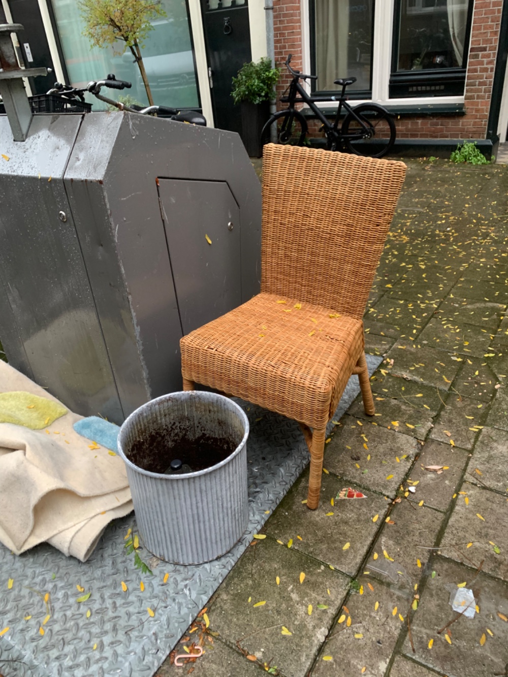 Outside chair and a large plant pot maybe