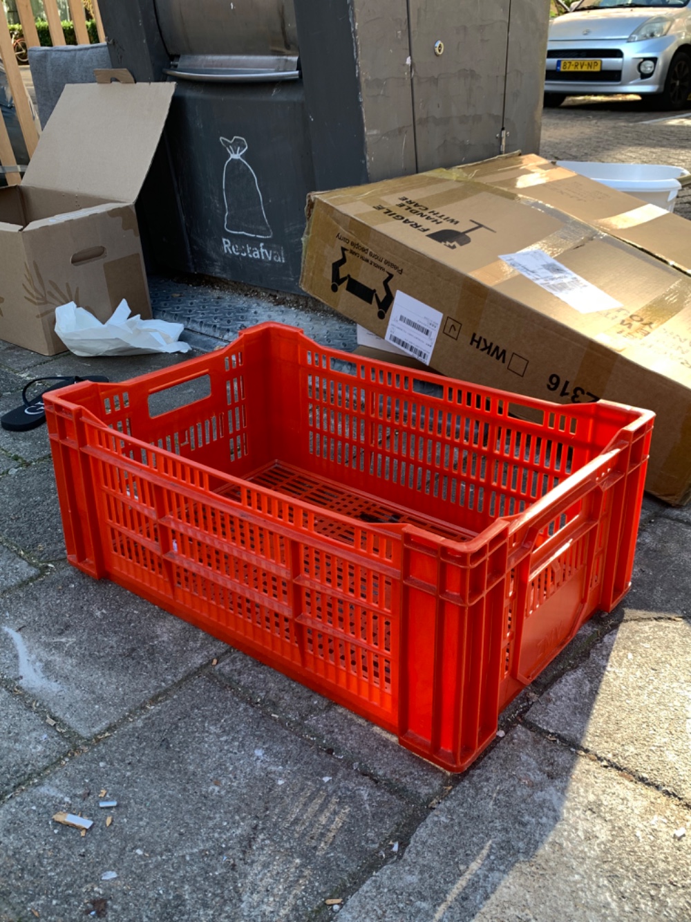 Wide red plastic box with a small dark stain inside