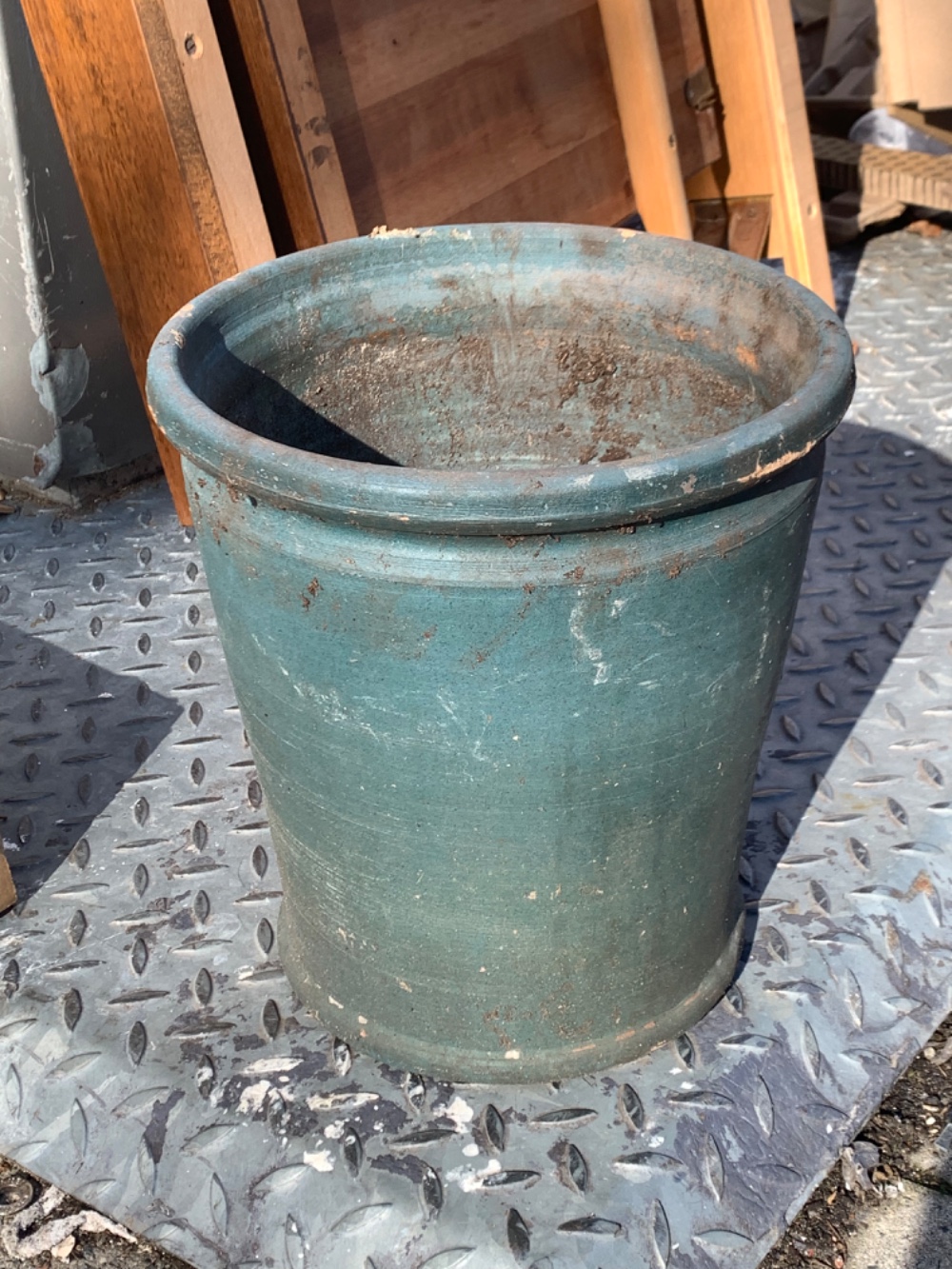 Big green ceramic plant pot. A bit damaged on one side, but there is no hole 