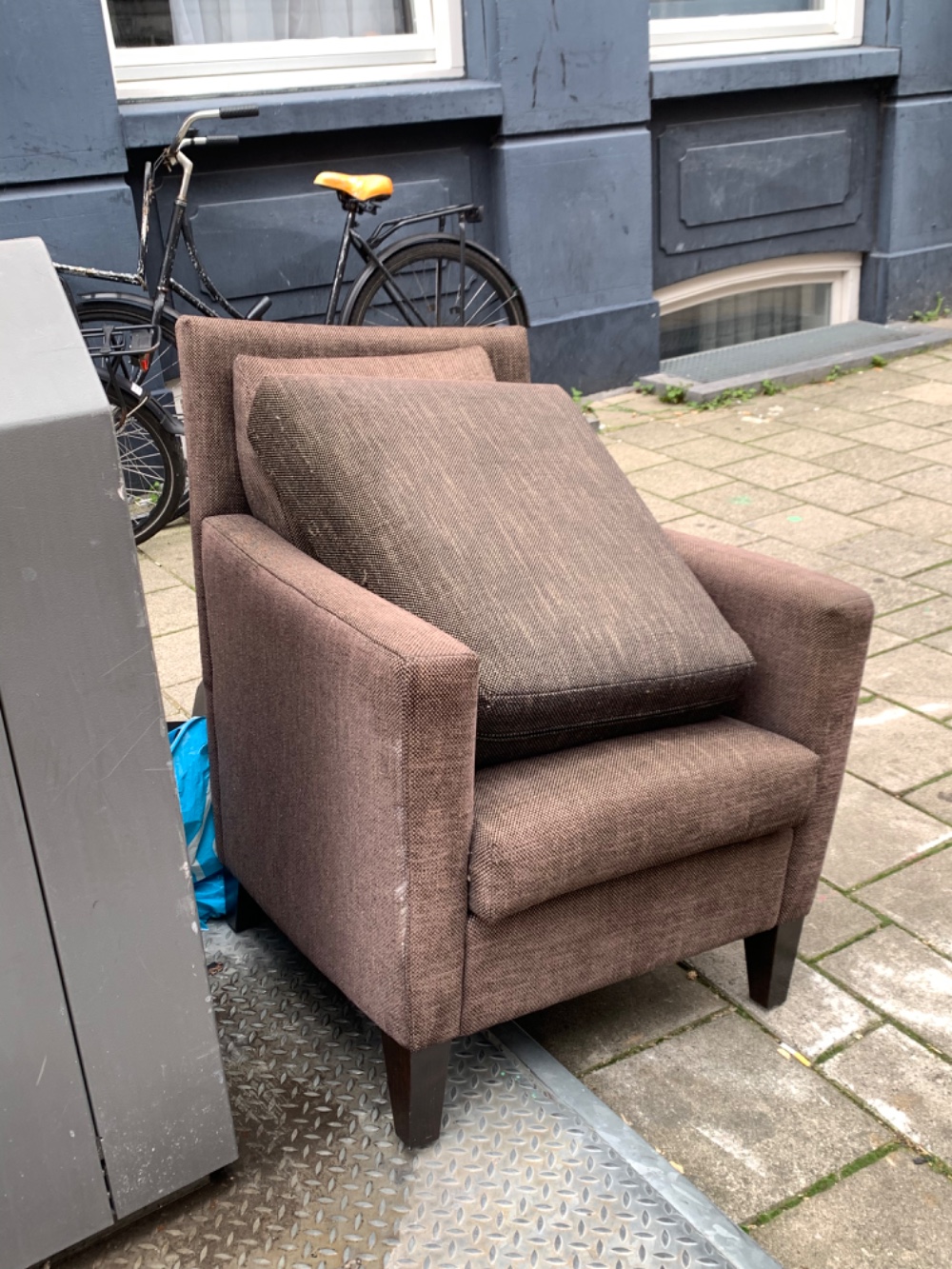 Brown armchair with extra pillows