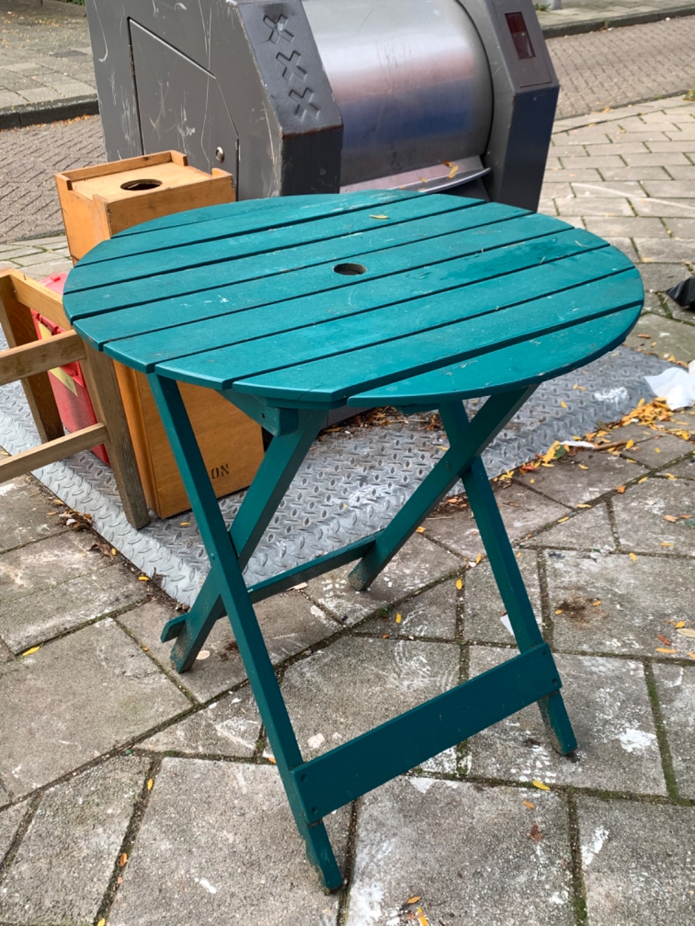 Green outside table. It can be folded