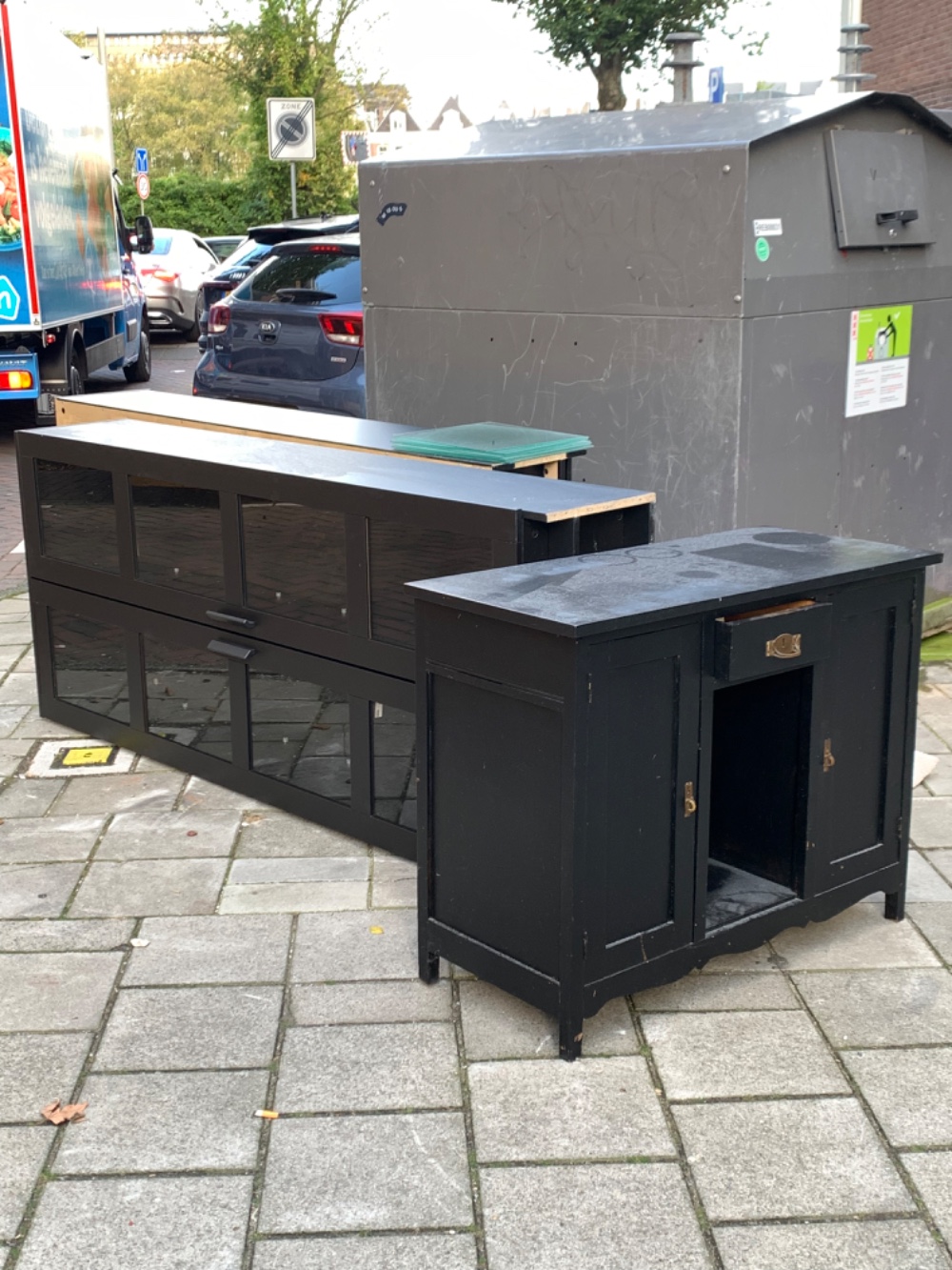 Two black cupboards with glass doors
And a dresser?