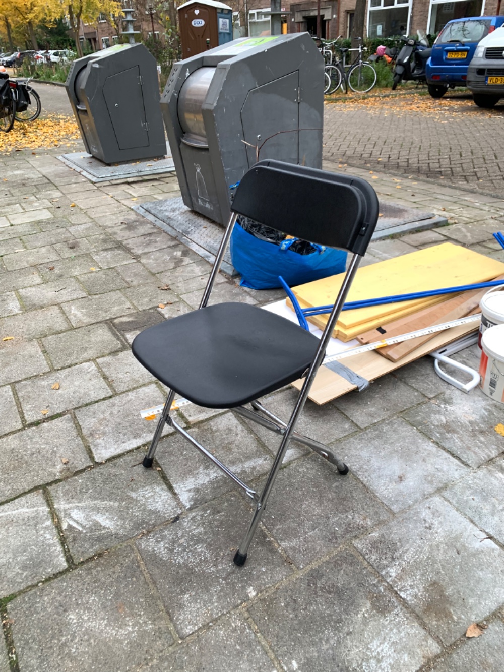 Two folding chairs (one a the bottom of the pile) and a clothes rail