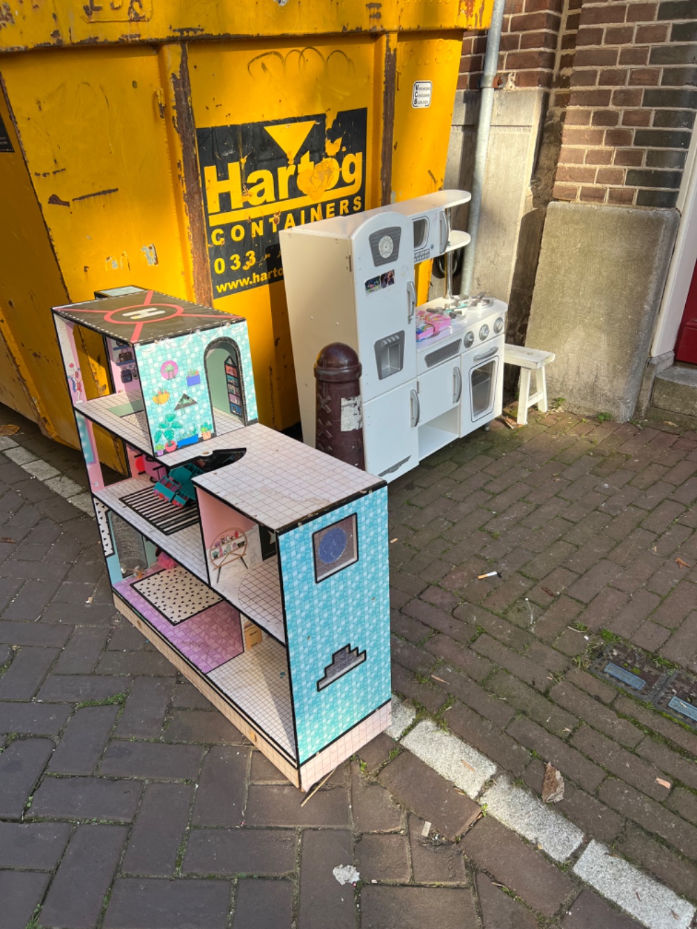 kids kitchen and a doll house. some kids chairs