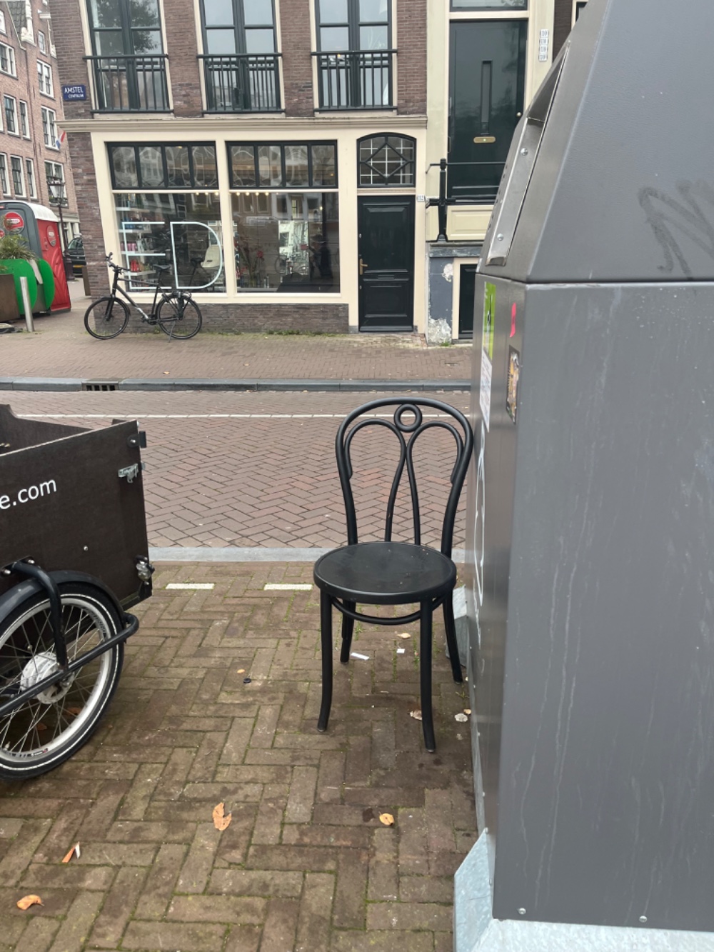 Three black chairs, a latern (without light buks, I think it’s for a candle), two big blue plastic planters as wel as a smaller white metal planter.  photo 2