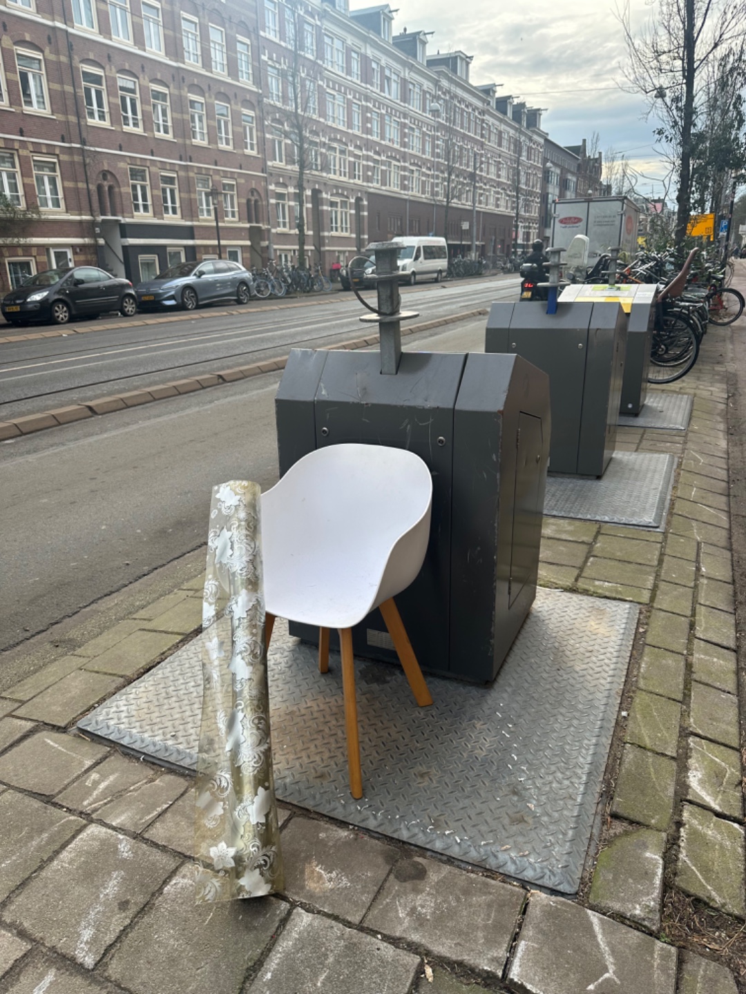 White plastic chair, rubber roll of material