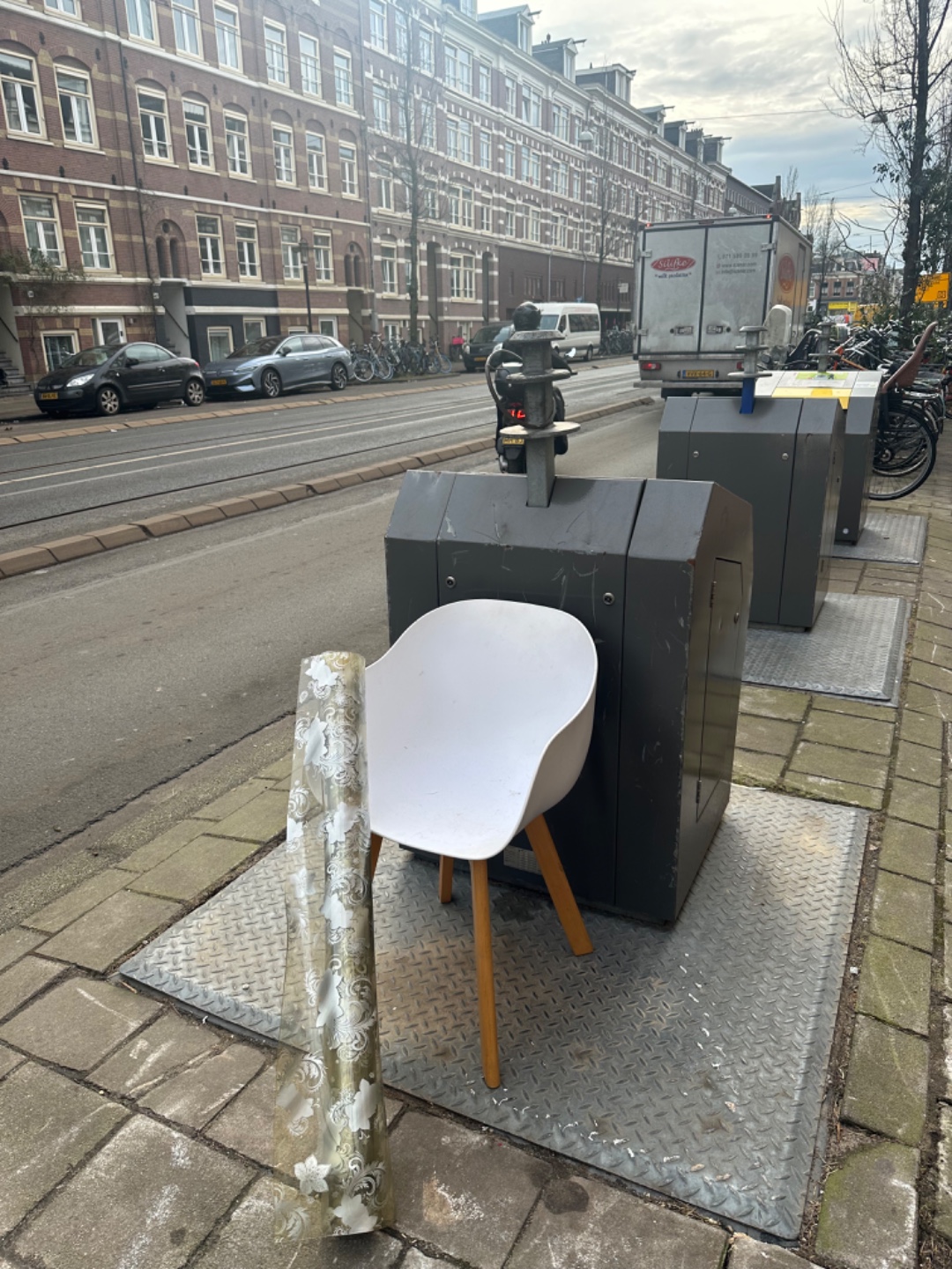 White plastic chair, rubber roll of material photo 2