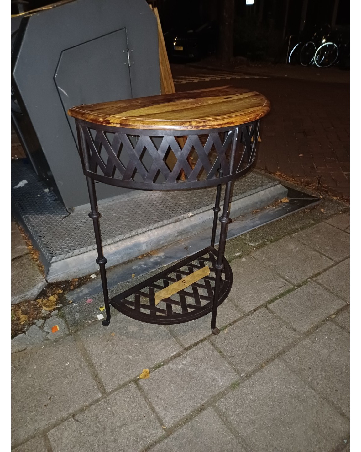 Really nice solid wood and metal half moon table, maybe like 50/60ish cm wide. Pretty heavy.