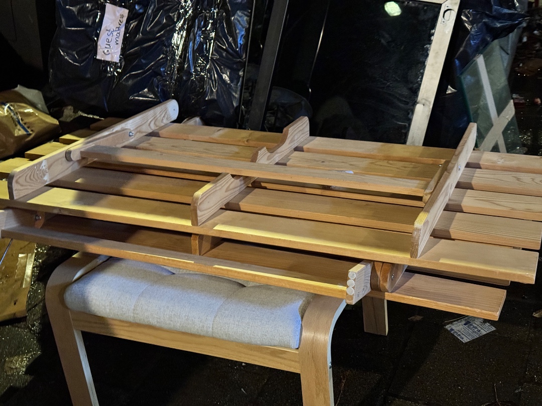 IKEA GRANKULLA sofa bed (1.5 - 2 person version) with MASSUM mattress (in the plastic bag behind it), POÄNG footstool/ottoman w off-white pillow, one standing lamp with broken shade, one ceiling lamp.