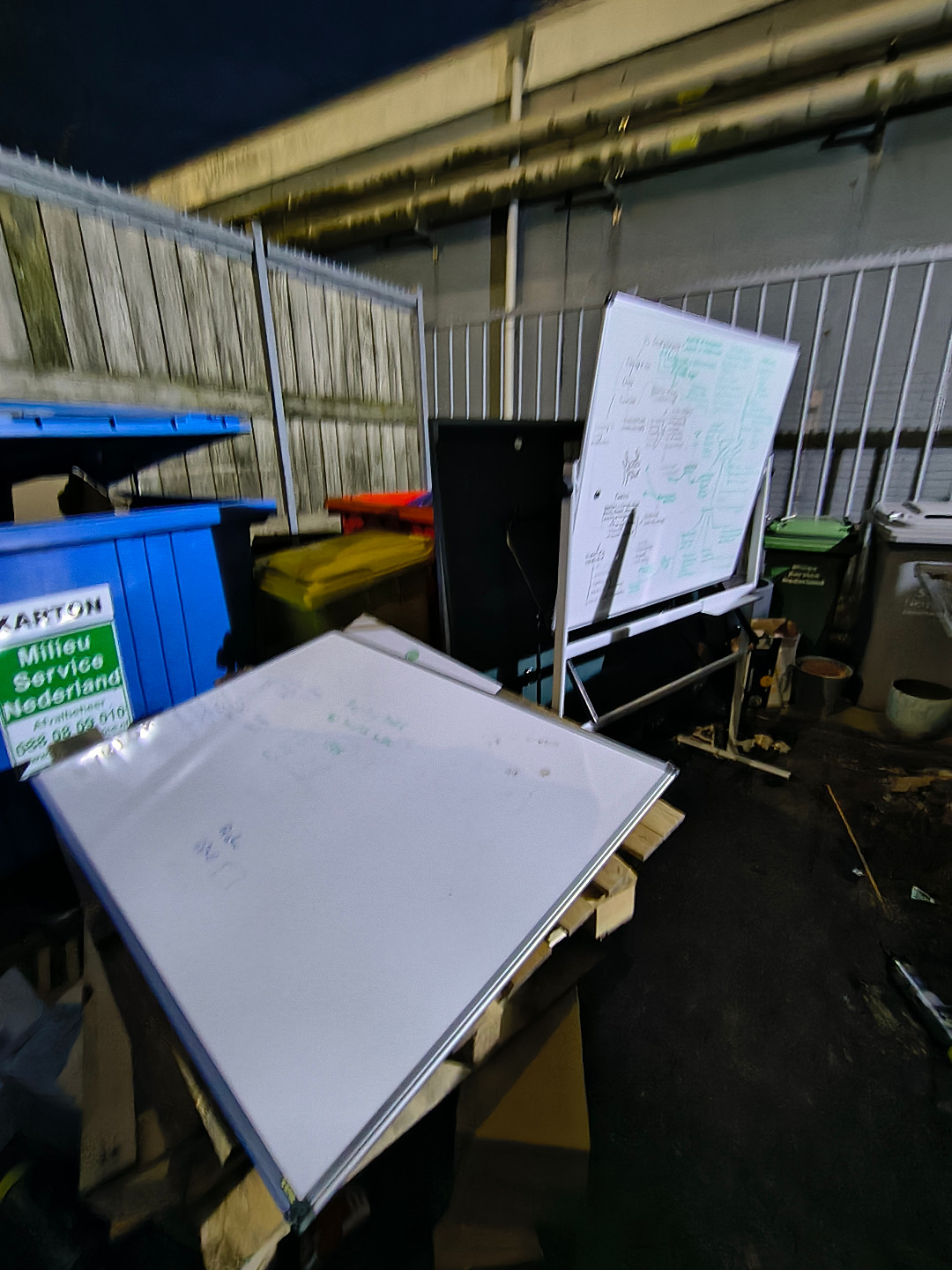 A couple of whiteboards and a few empty flowerpots. photo 1