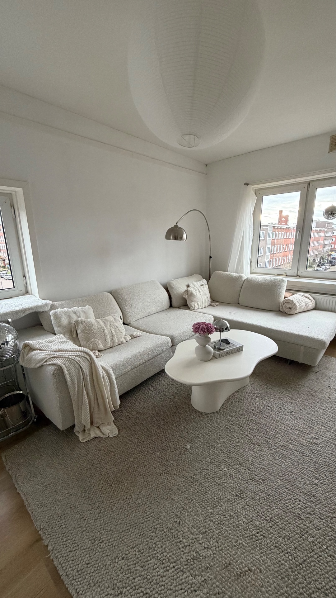 This Roche Bobois couch is up for taking! We wrapped it ourselves with a white teddie material, the original couche is brown/sand color. There are some damages on the side and bottom caused by our cat, but nothing noticeable if placed against a wall :) perfect for a student house photo 1