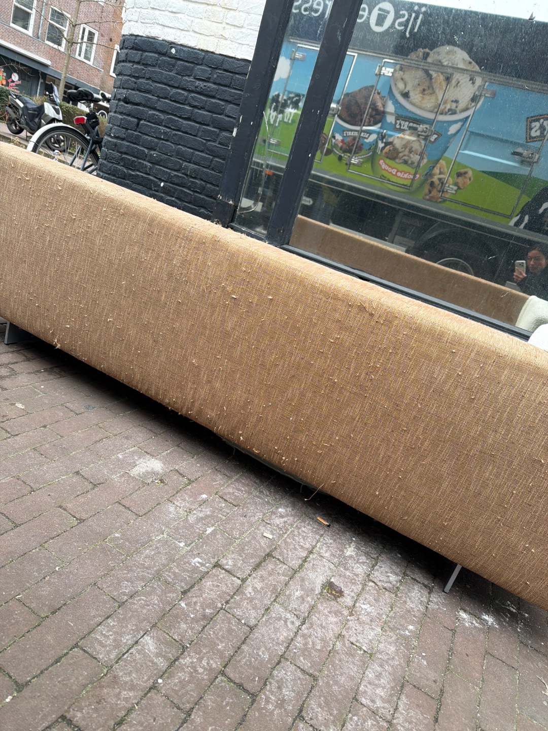 This Roche Bobois couch is up for taking! We wrapped it ourselves with a white teddie material, the original couche is brown/sand color. There are some damages on the side and bottom caused by our cat, but nothing noticeable if placed against a wall :) perfect for a student house photo 3