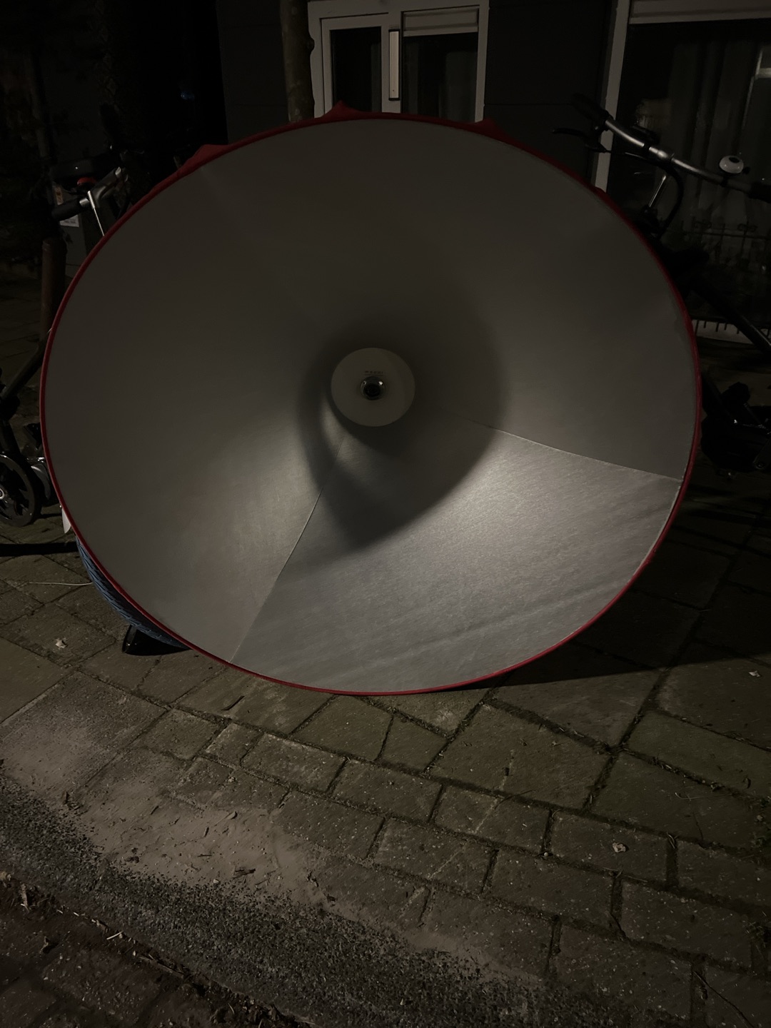 Enormous red lampshade from red fabric, inside had silver lining.  Grensstraat 31, oost photo 2