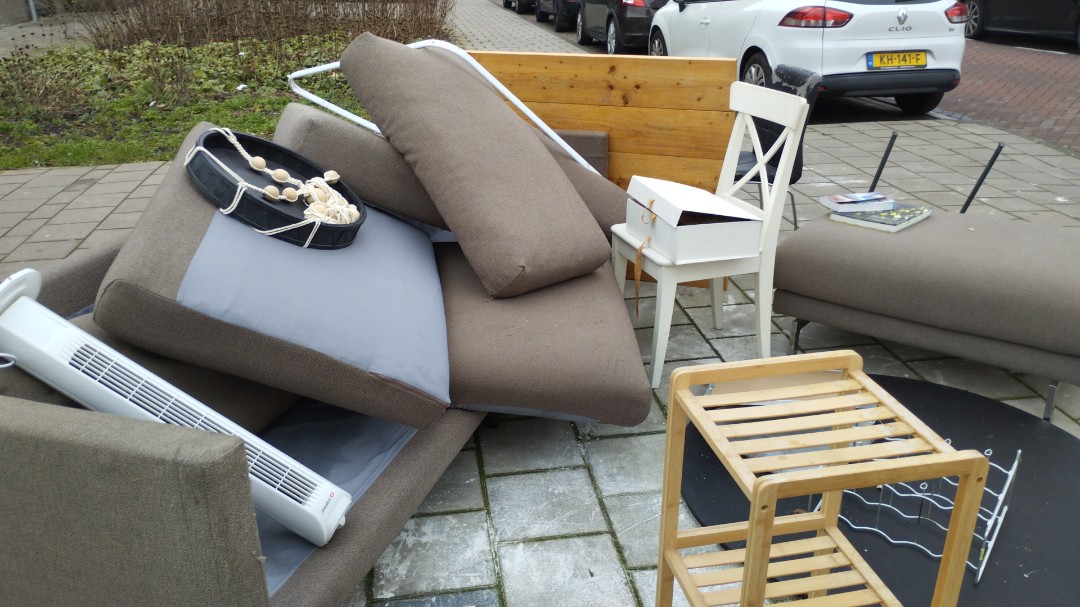 Couch, big wood table, some chairs, ventilator, etc