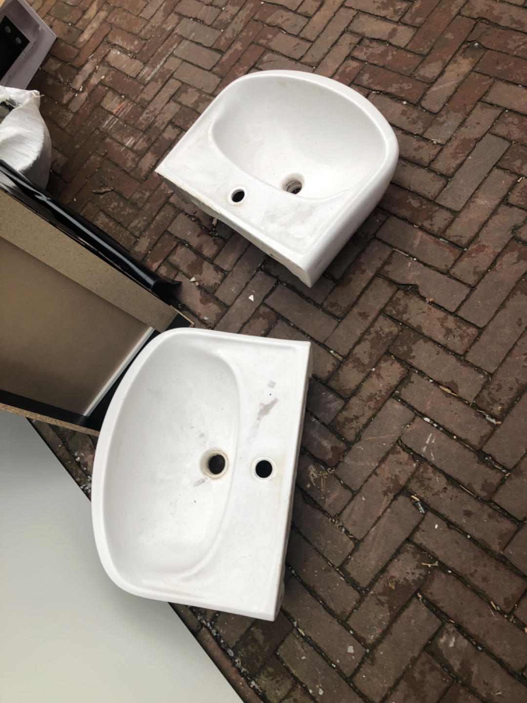 Two wash bassins and a chest of drawer on its side. photo 1