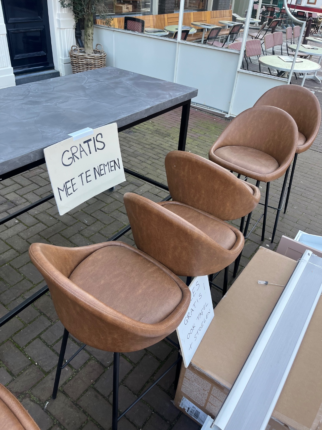 Table, high chairs, curtain. Box of pram is empty.