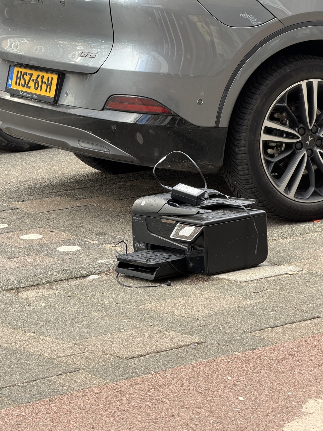 Printer on a sidewalk in front of Eyewish store 1