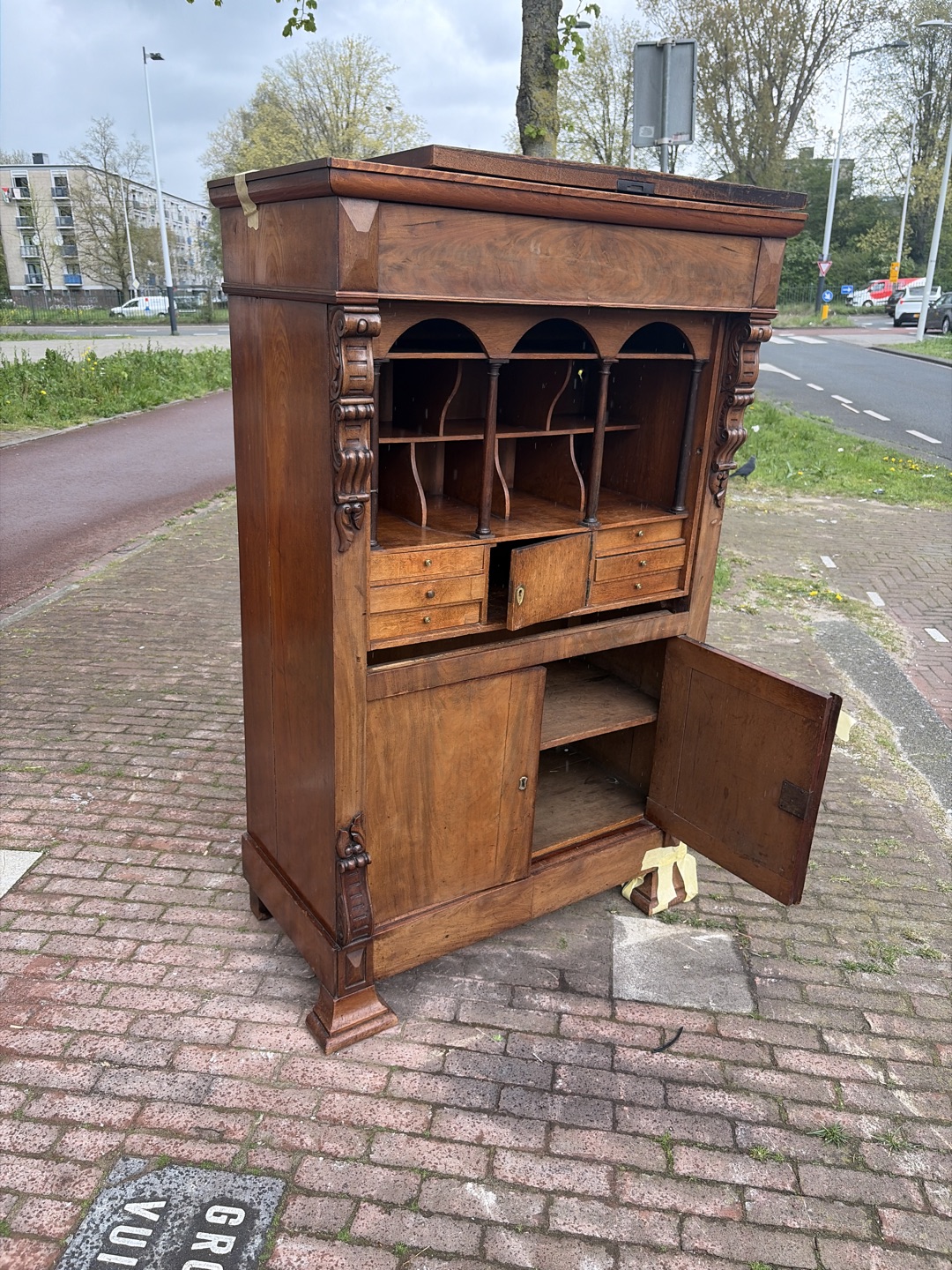 There is a beautiful-looking wooden cupboard by the road; some panels are off, but I think it's easily mendable. 1