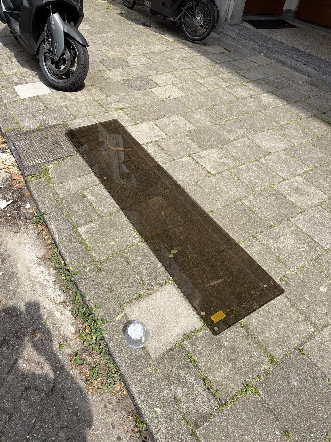 Tinted glass panel, new. The garbage collector did not want to take it. 1