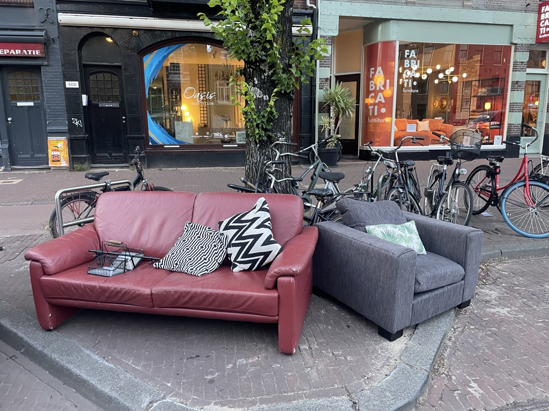 red leather couch, armchair, pillows, wall spice rack 1